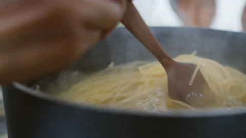 Spaghetti noodle Boiled in boiling water in a pot on the stove Stock Footage 130666653