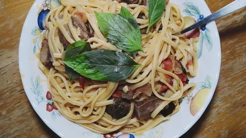 Spaghetti with Pan Fried Veal and Fresh Basil in White Ceramic Bowl Stock Footage 343429933
