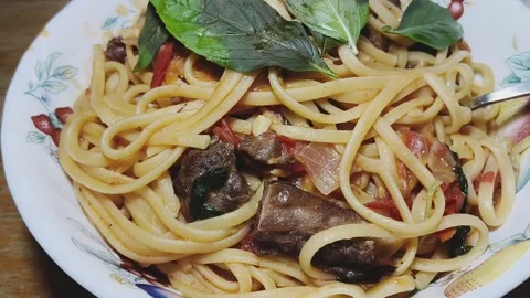 Spaghetti with Pan Fried Veal and Fresh Basil in White Ceramic Bowl Stock Footage 343429937
