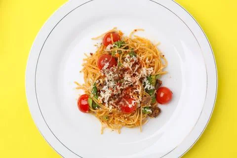 Spaghetti pasta with cherry tomatoes and grated cheese Stock Photos