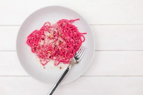 Spaghetti pasta with pink beetroot sause. Delicious lunch Stock Photos