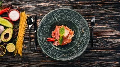 Spaghetti paste with parmesan cheese and tomatoes. Italian cuisine. Top view. Stock Photos