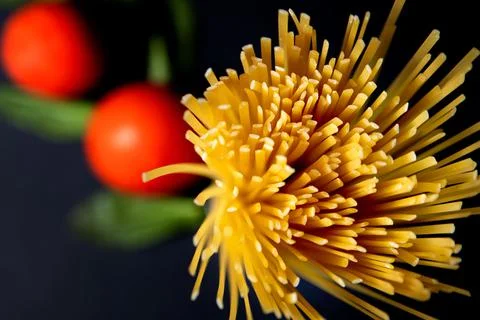 Spaghetti paste, tomato and other products for cooking on dark background top Stock Photos