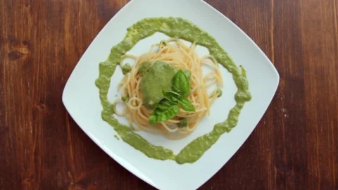 Spaghetti with pesto with a rotating view seen from above Stock Footage 94835572