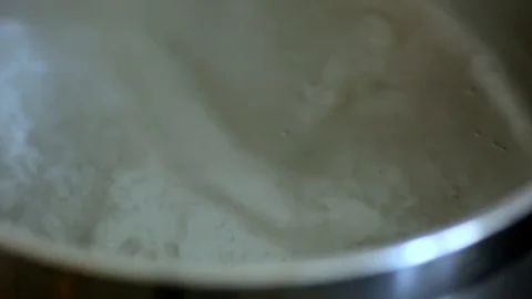 Spaghetti is placed in boiling water. Close-up. Stock Footage 129380951