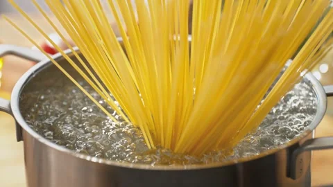 Spaghetti Placed Vertically into the Pot of Boiling Water Spreads out Stock Footage 278831159