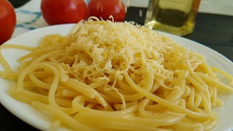Spaghetti plate drops cheese, slow-motion shot Stock Footage 88632776