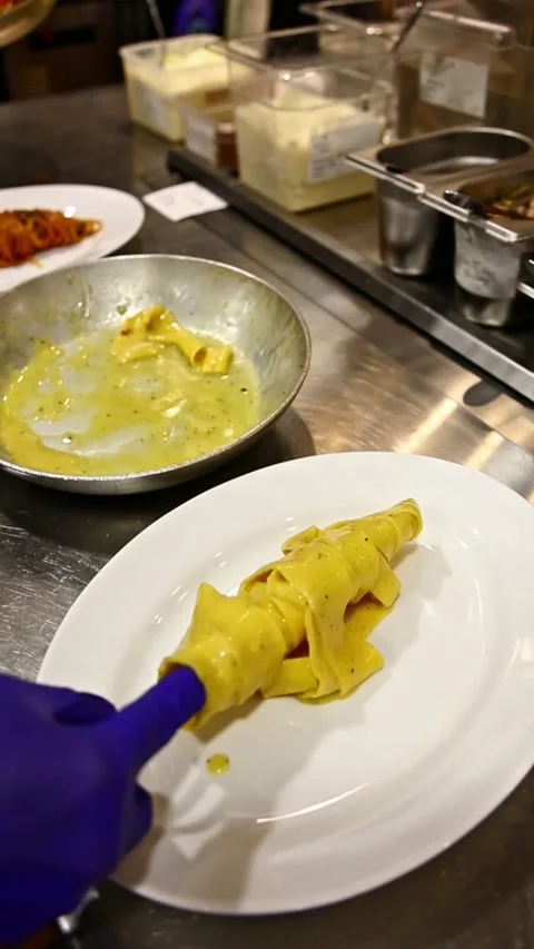 Spaghetti pot with yellow cheese on kitchen table. Stock Footage 311014025