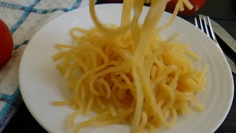 Spaghetti is poured into a plate, slow-motion shooting Stock Footage 88632715