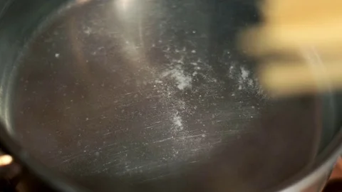 Spaghetti is put in boiling salted water. Preparation pasta Stock Footage 75055998