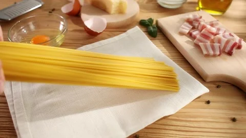 Spaghetti put on the table. Ingredients for pasta carbonara. High angle view. Stock Footage 244449516