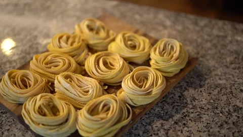 Spaghetti rolls on cutting board in restaurant Stock Footage 241484025