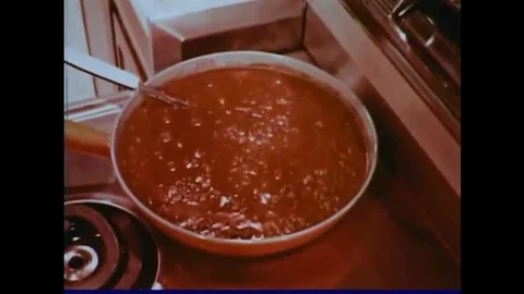 Spaghetti sauce with lamb meat is prepared, in a kitchen, in 1965. Stock Footage