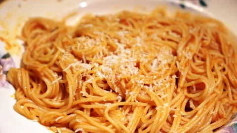 Spaghetti with sausage on a dish and adding cheese Stock Footage 145170198