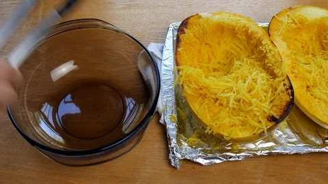 Spaghetti squash being put into a bowl. Stock Footage 106607507