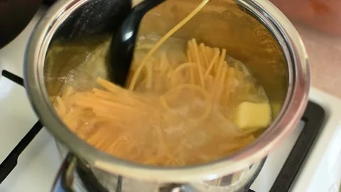Spaghetti submerged in boiling water inside cooking pot. Stock Footage 330530651