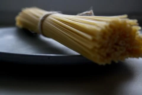 Spaghetti tied in a roll close up Stock Photos