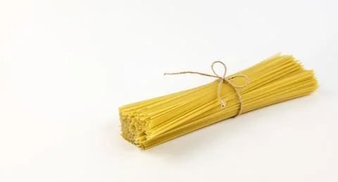 Spaghetti tied with a thread isolated on a white background. Stock Photos