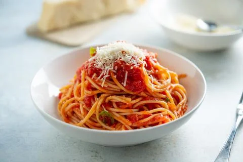 Spaghetti with tomato sauce and basil on a plate Stock Photos