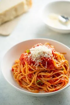 Spaghetti with tomato sauce and basil on a plate Stock Photos