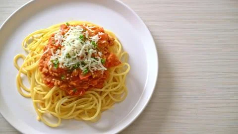 Spaghetti with tomato sauce and herbs on a white plate Stock Photos