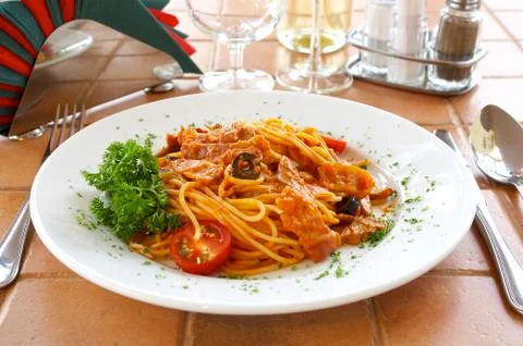 Spaghetti with a tomato sauce on a table in cafe Stock Photos