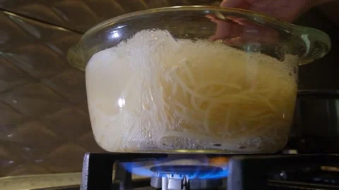Spaghetti in a transparent pan with boiling water. Spaghetti in boiling water. S Stock Footage 283630402