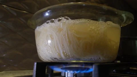 Spaghetti in a transparent pan with boiling water. Spaghetti in boiling water. S Stock Footage 283630448