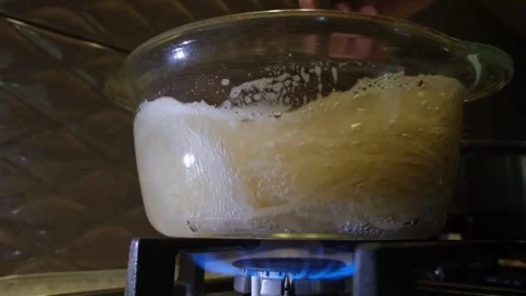 Spaghetti in a transparent pan with boiling water. Spaghetti in boiling water. S Stock Footage 283630494