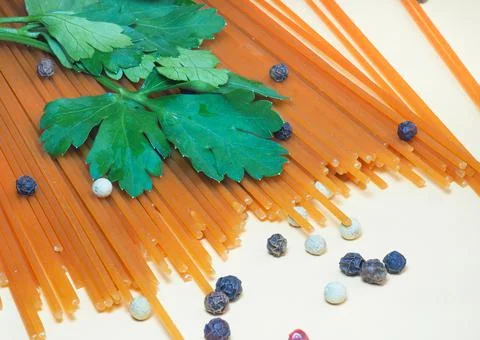Spaghetti of two types on the table. Tomato and buckwheat pasta. Italian food Stock Photos