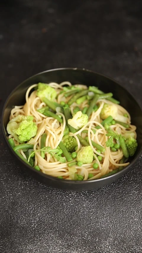 Spaghetti vegetables green peas, broccoli, string beans vegetarian pasta food Stock Footage 315980214