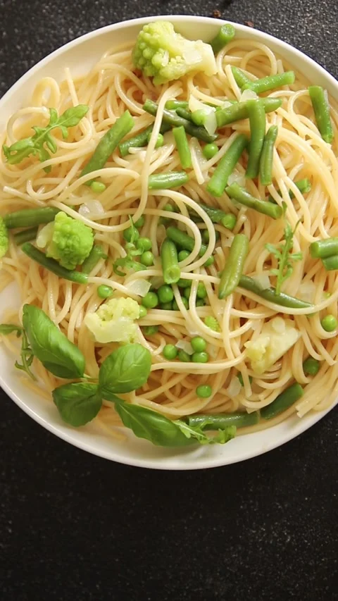 Spaghetti vegetables green peas, broccoli, string beans vegetarian pasta food Stock Footage 315980246