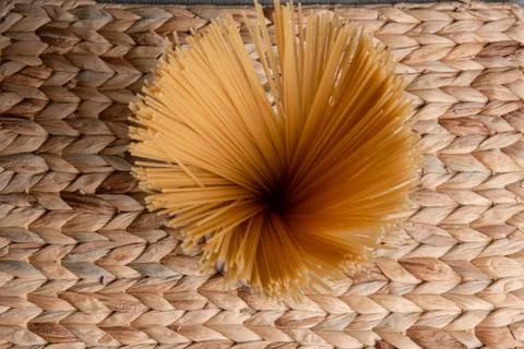 Spaghetti on wicker background Stock Photos