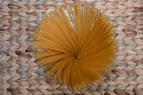 Spaghetti on wicker background Stock Photos