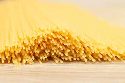 Spaghetti yellow background close. raw pasta macro 스톡 사진
