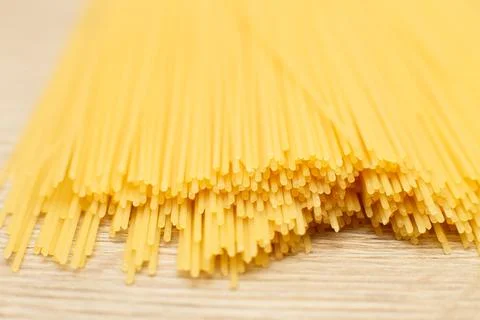 Spaghetti yellow background close. raw pasta macro 스톡 사진