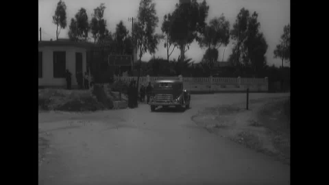 SPAIN - 1930s - A car stops in front of a border control booth. Border control Stock Footage 340571522