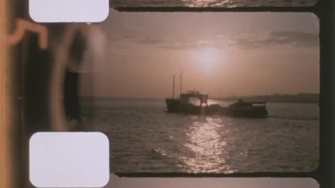 Spain 1960s, cargo vessel sailing at sunset on open water Stock Footage 339979793