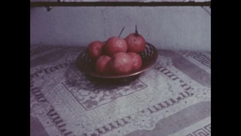 Spain 1960s: A spoon stirs a shallow white bowl filled with dark bean soup on a Stock Footage 340669734