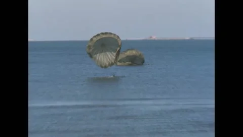 SPAIN - 1964 - Two SEAL divers drift on parachutes and land in the water. Divers Stock Footage 316680287