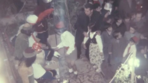Spain - 1975: kids stand in queue collect Christmas presents from Santa Claus Stock Footage 232857704