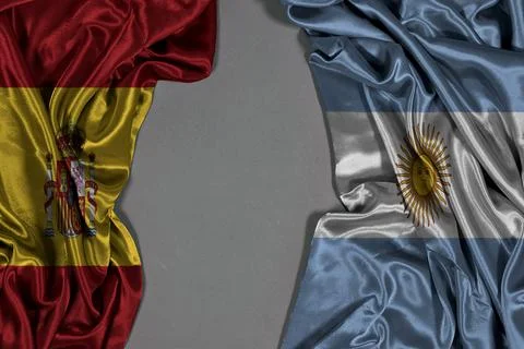 Spain And Argentina Flags Draped Facing Each Other On Gray Background Representi Stock Photos