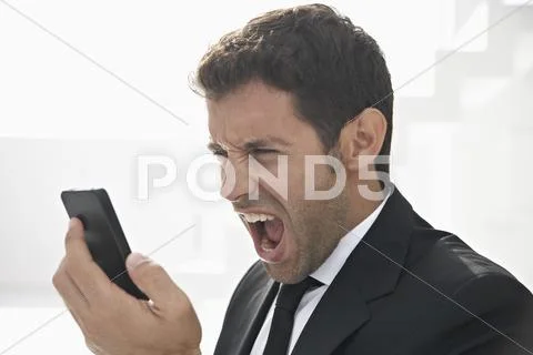 Spain, Businessman shouting on mobile phone Stock Photos
