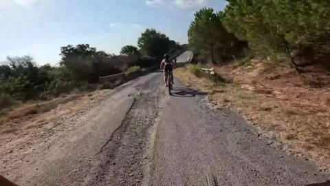 Spain: Cyclist crashes after fast overtake on rough road in Pineda de Mar... Stock Footage 326019376