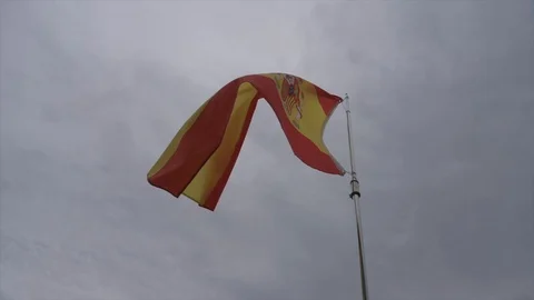 Spain Flag 120p slow-motion blowing in wind wide angle and low angle on overcast Stock Footage 122174178
