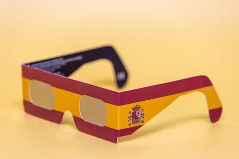 Spain flag colored eclipse glasses with coat of arms Stock Photos