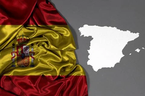 Spain Flag Draped Over Fabric With White Silhouette Map Of Spain Fotos Stock