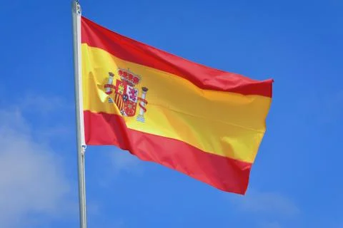 Spain flag in the wind on the mast Stock Photos