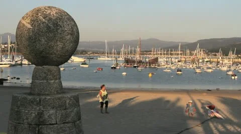 Spain Galicia Baiona harbor yellow woman Stock Footage
