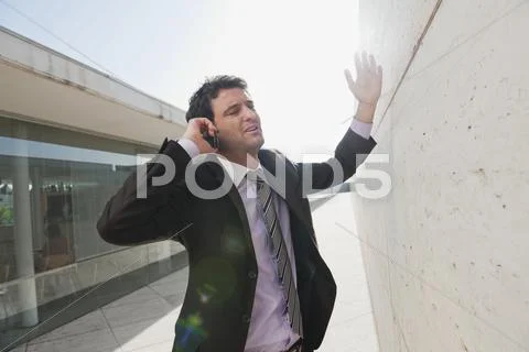 Spain, Mallorca, Businessman using mobile phone, gesturing Stock Photos